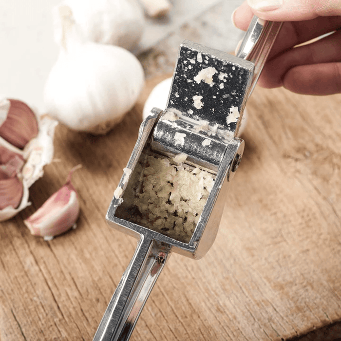 Royal Industries 7 inch Aluminum Garlic Press  This garlic press features pressing nubs that force the garlic through a stainless steel blade. It is extremely easy cleaning and won't leave your hands smelling like garlic all day-ROY GP Hannah's Variety Store