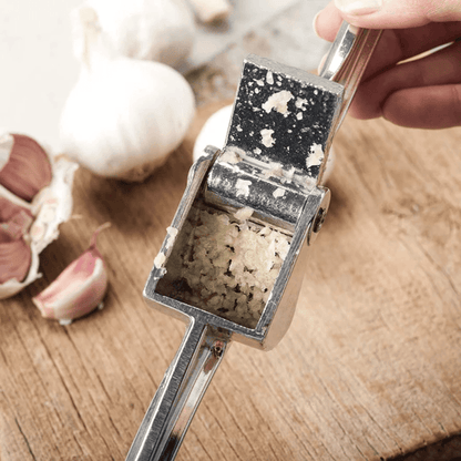 Royal Industries 7 inch Aluminum Garlic Press  This garlic press features pressing nubs that force the garlic through a stainless steel blade. It is extremely easy cleaning and won't leave your hands smelling like garlic all day-ROY GP Hannah's Variety Store