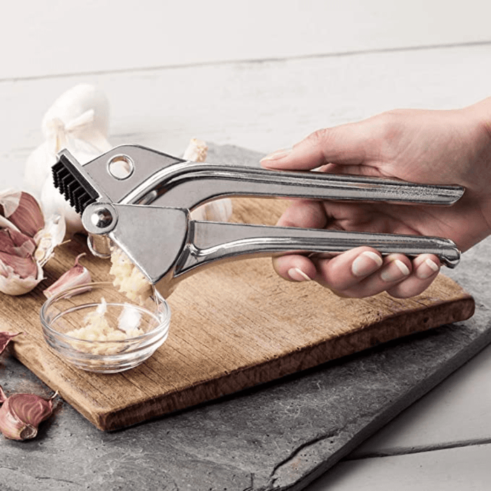 Royal Industries 7 inch Aluminum Garlic Press  This garlic press features pressing nubs that force the garlic through a stainless steel blade. It is extremely easy cleaning and won't leave your hands smelling like garlic all day-ROY GP Hannah's Variety Store