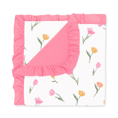 Ruffle Baby Blanket in Tulip 0.5 with the corner flipped down showing the pink backing