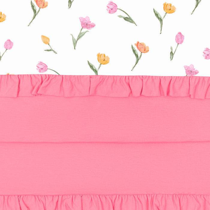 Close up of the Ruffle Baby Blanket in Tulip 0.5 showing the pink backing and floral print top layer