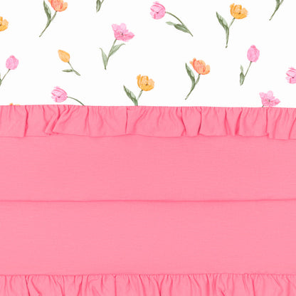 Close up of the Ruffle Baby Blanket in Tulip 0.5 showing the pink backing and floral print top layer