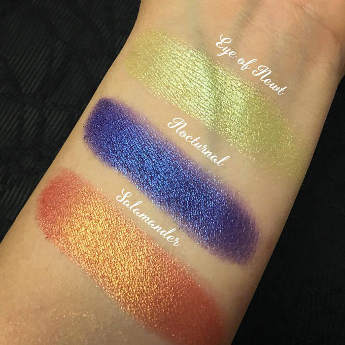 Top angled arm swatches on fair skin tone of Salamander Duochrome Eyeshadow compared to Eye of Newt, Nocturnal