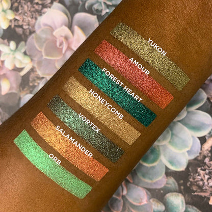 Collage of arm swatches on deep skin tone of Mojave Bundle including Yukon, Amour, Forest Heart, Honeycomb, Vortex, Salamander, Orb