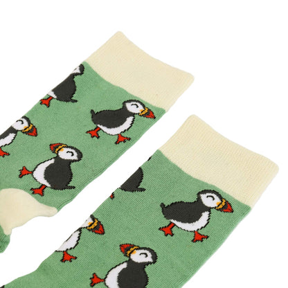 Green socks with puffin pattern on a white background