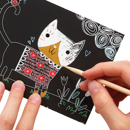 Hands scratching cat artwork of the OOLY Cutie Cats Scratch and Scribble Mini Scratch Art Kit