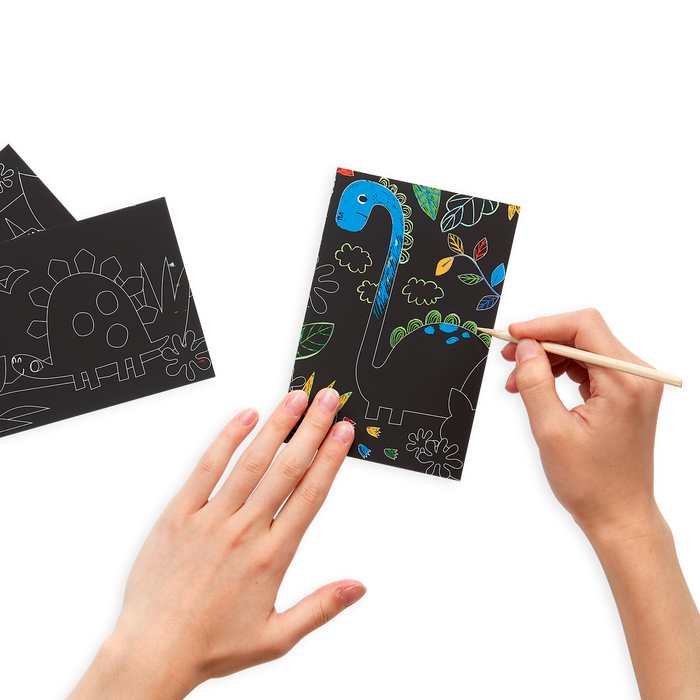 Person drawing on the Dinosaur Days Scratch and Scribble Mini Scratch Art Kit