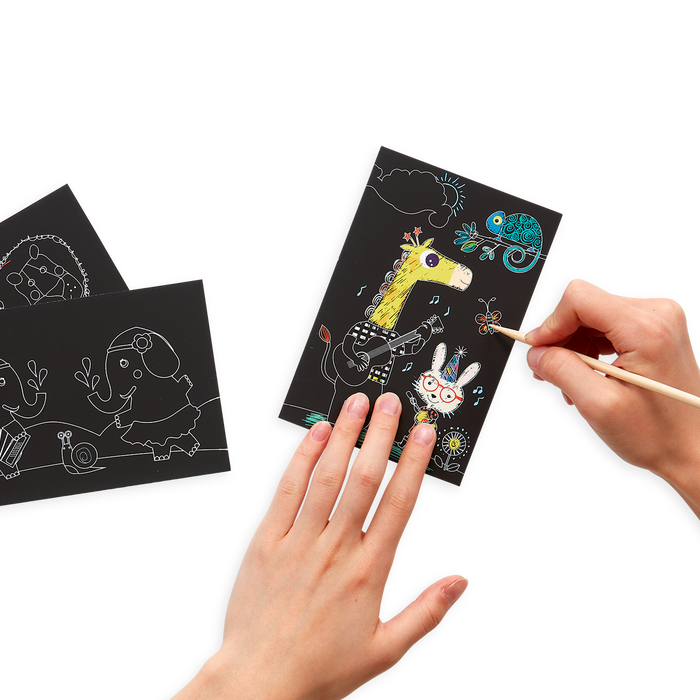 Hands drawing on the Safari Party Scratch and Scribble Mini Scratch Art Kit