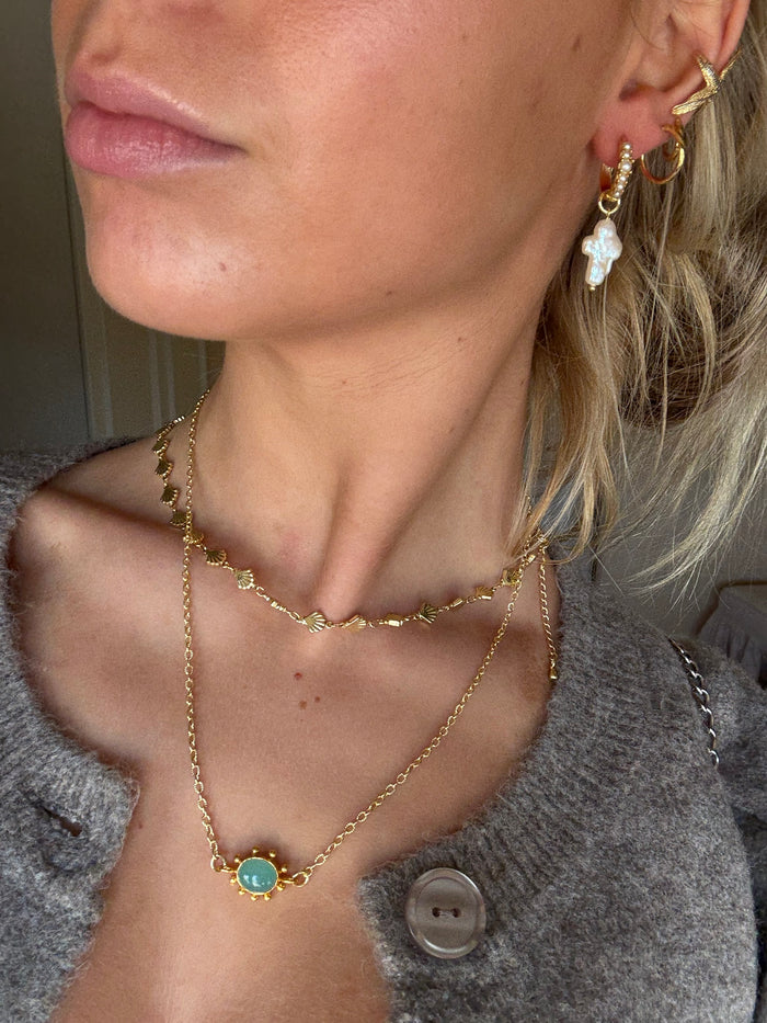 Layered gold necklaces styled for everyday jewellery stack