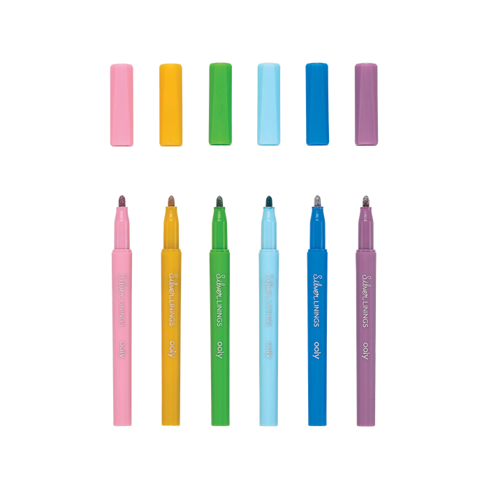 Six uncapped OOLY Silver Linings Outline Markers in a row with a white background