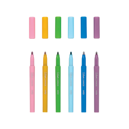Six uncapped OOLY Silver Linings Outline Markers in a row with a white background