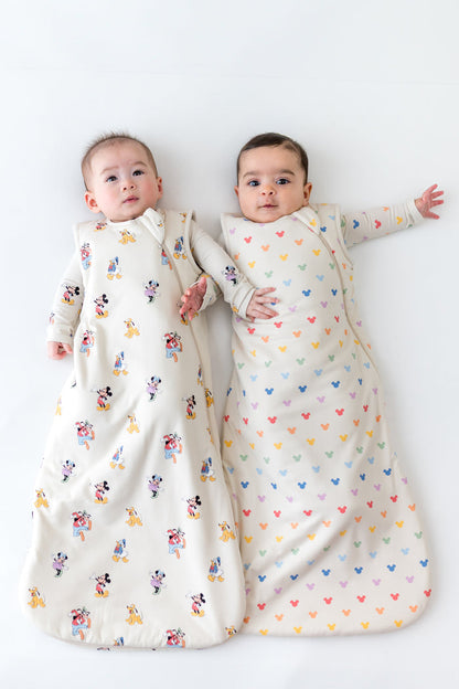 2 babies wearing sleep sacks in mickey mouse patterns