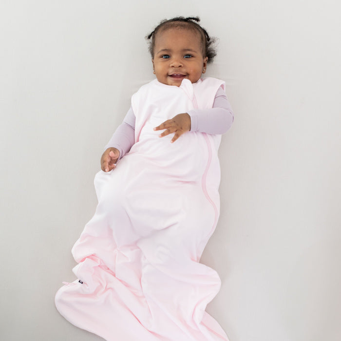 Infant wearing Kyte Baby Sleep Bag in Sakura 0.5
