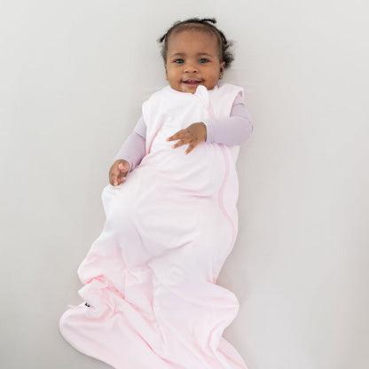 Infant wearing Kyte Baby Sleep Bag in Sakura 0.5