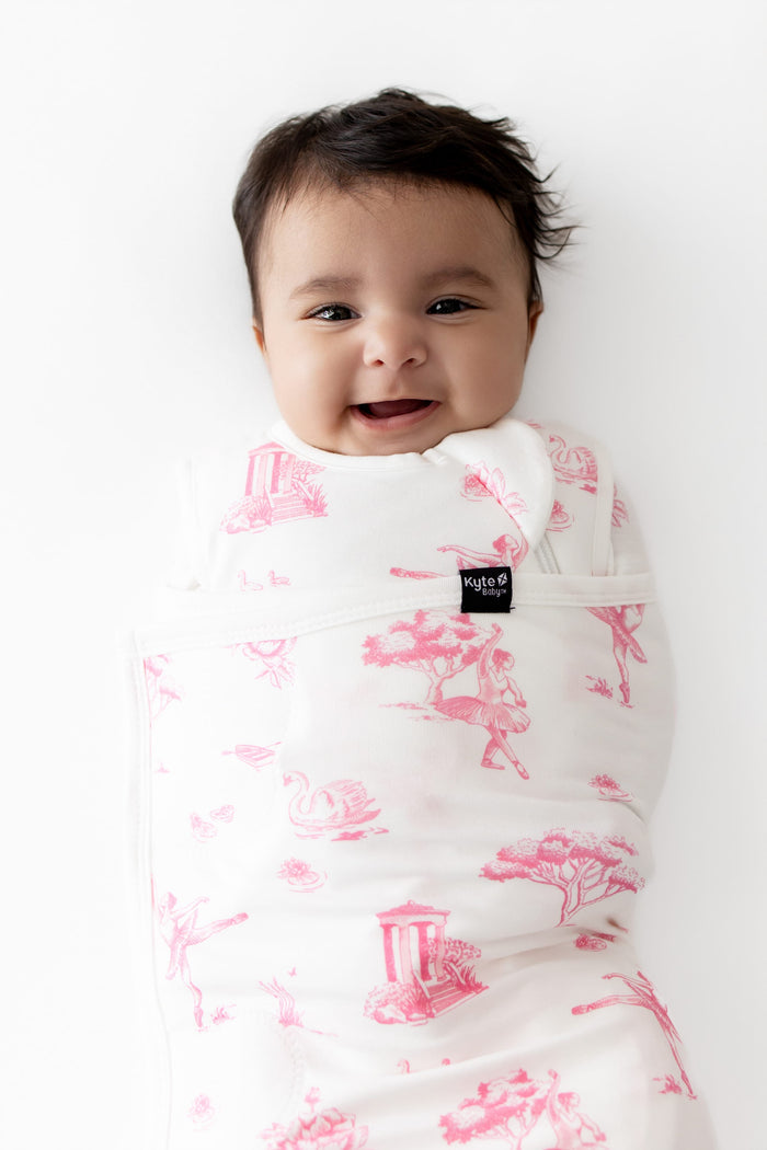 Close up of infant swaddled in the Sleep Bag Swaddler in Toile Ballet 1.0
