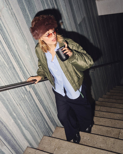 Steel Cup Set held by fashion-forward individual on stone stairs.