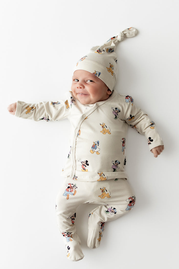 Baby in mickey patterned take me home set featuring a cap, kimono top and footed pant