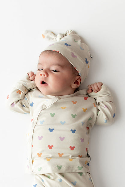 Baby in a colorful mickey head patterned kimono top and cap