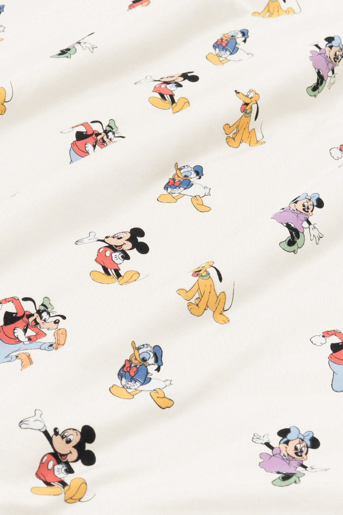Fabric with mickey mouse and friends print on an oat background