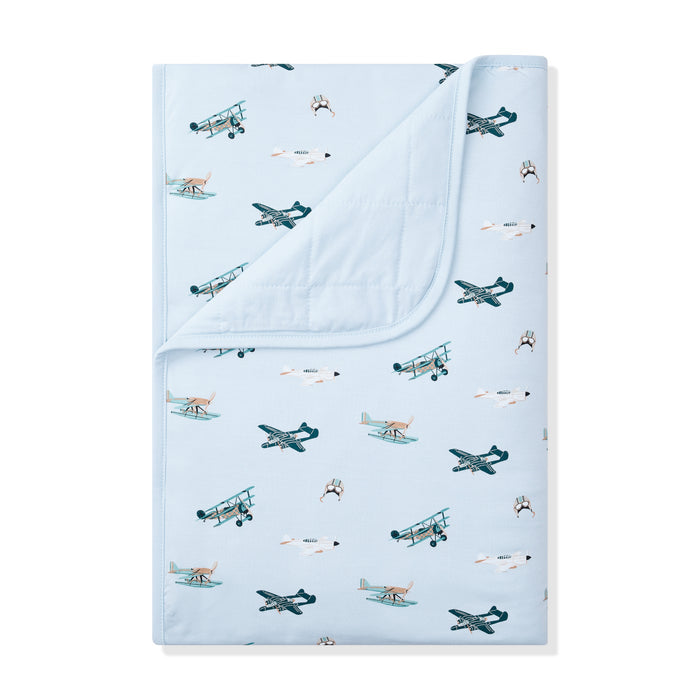 Toddler Blanket in Take Off 1.0 with the corner folded down showing the light blue backing