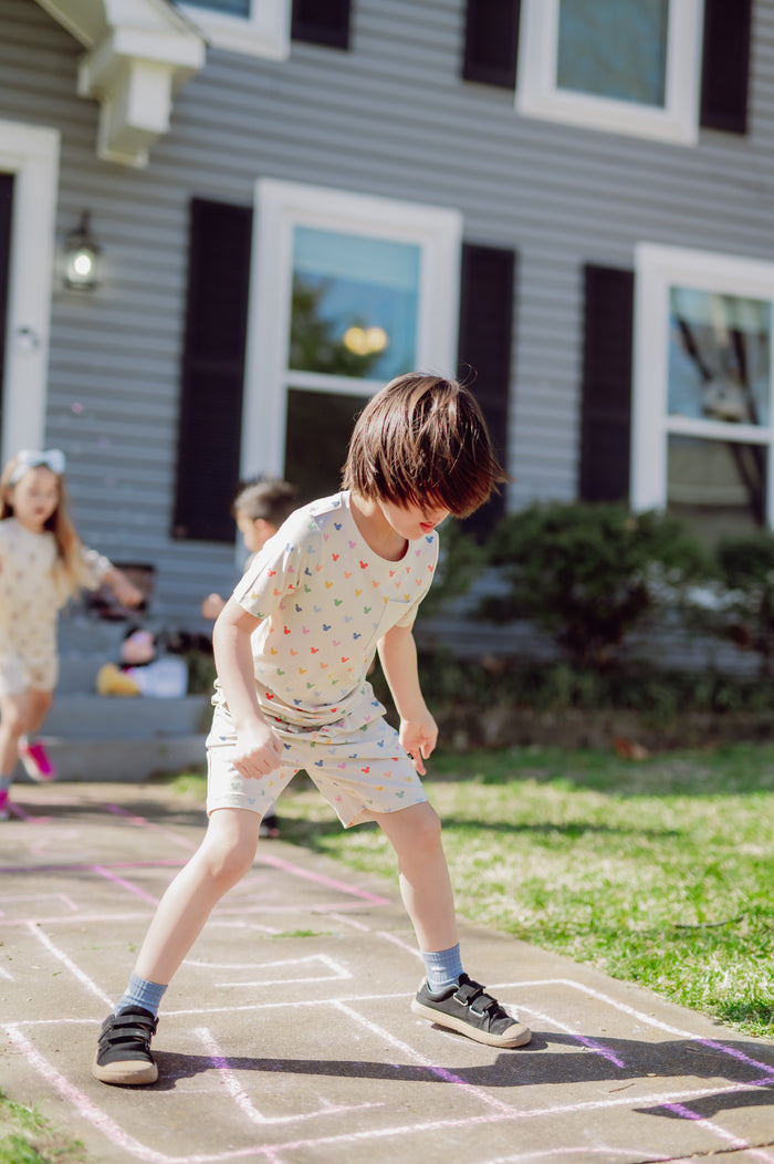 Child playing hopscotch in front of a house