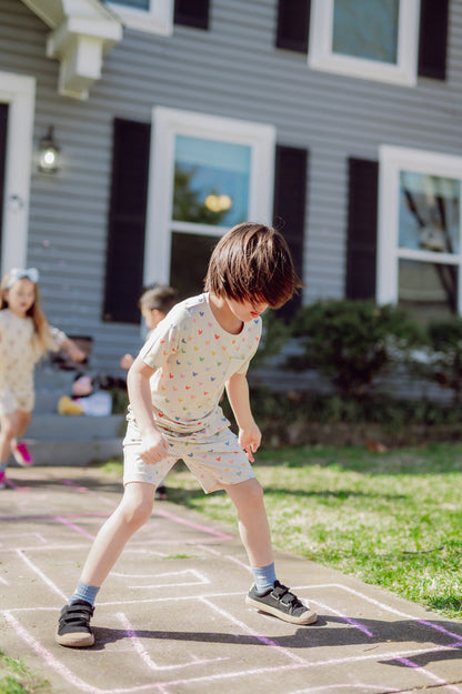 Child playing hopscotch in front of a house