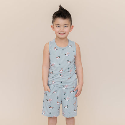 Smiling boy modeling the Toddler Tank Top in Mallard Duck and matching drawstring shorts in mallard duck