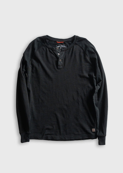 Black long-sleeve henley shirt with buttoned placket, displayed on a gray background. Simple, casual design for everyday wear.