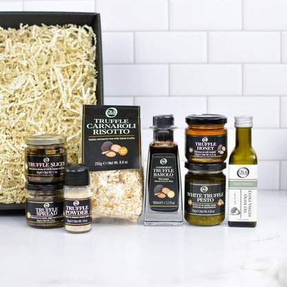 Collection of truffle products including slices, powder, and oils on a kitchen counter.