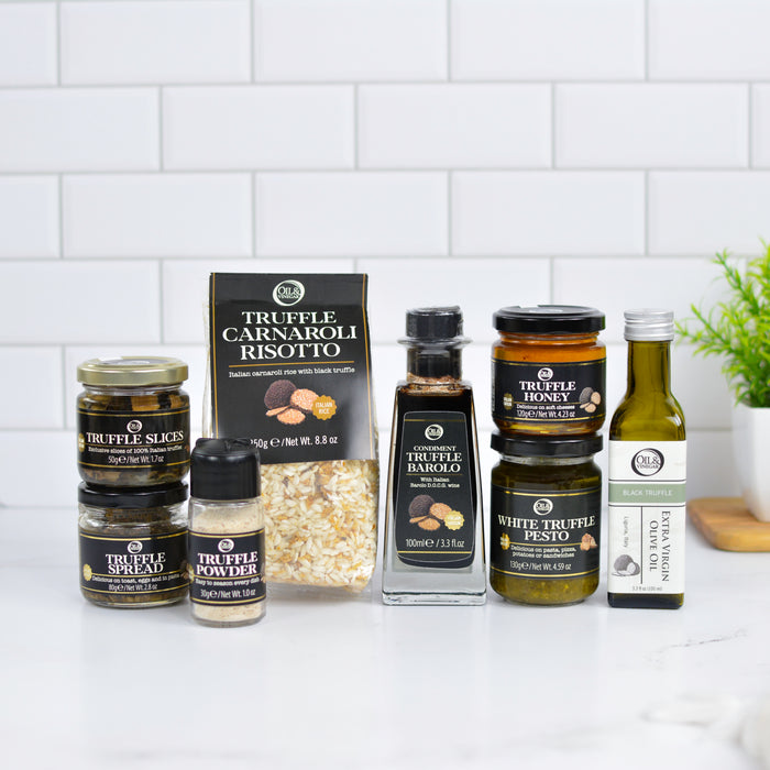 Collection of truffle products including jars, a box, and bottles on a kitchen counter.