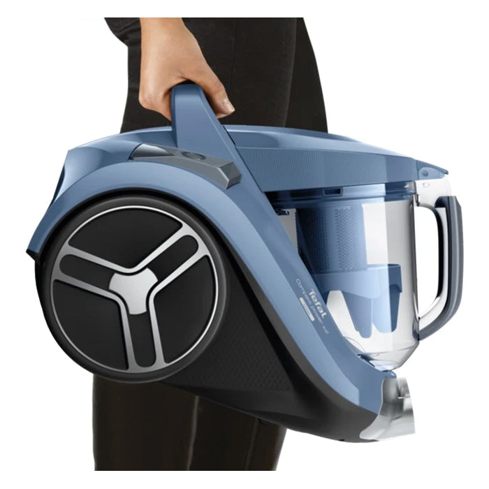 Blue and black vacuum cleaner held by a person on a white background