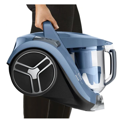 Blue and black vacuum cleaner held by a person on a white background