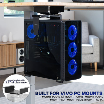 Computer case with blue LED fans on a desk in a room setting, featuring the spacer bracket designed for VIVO PC mounts.