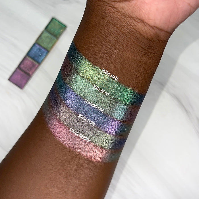 Top angled arm swatches on deep skin tone of Wall of Ivy Earth Vibrant Multichrome shifts compared to Hedge Maze, Climbing Vine, Royal Plum and Statue Garden