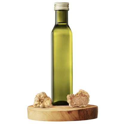 A bottle of extra virgin olive oil with a piece of white truffle next to it, all set on a wooden platform.