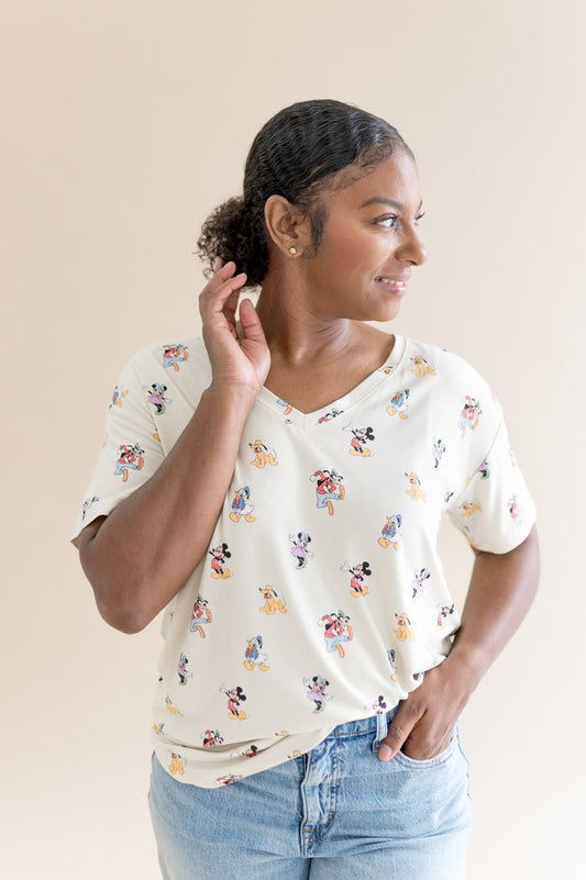 Woman wearing oversized v-neck tshirt that features a pattern of mickey mouse and friends