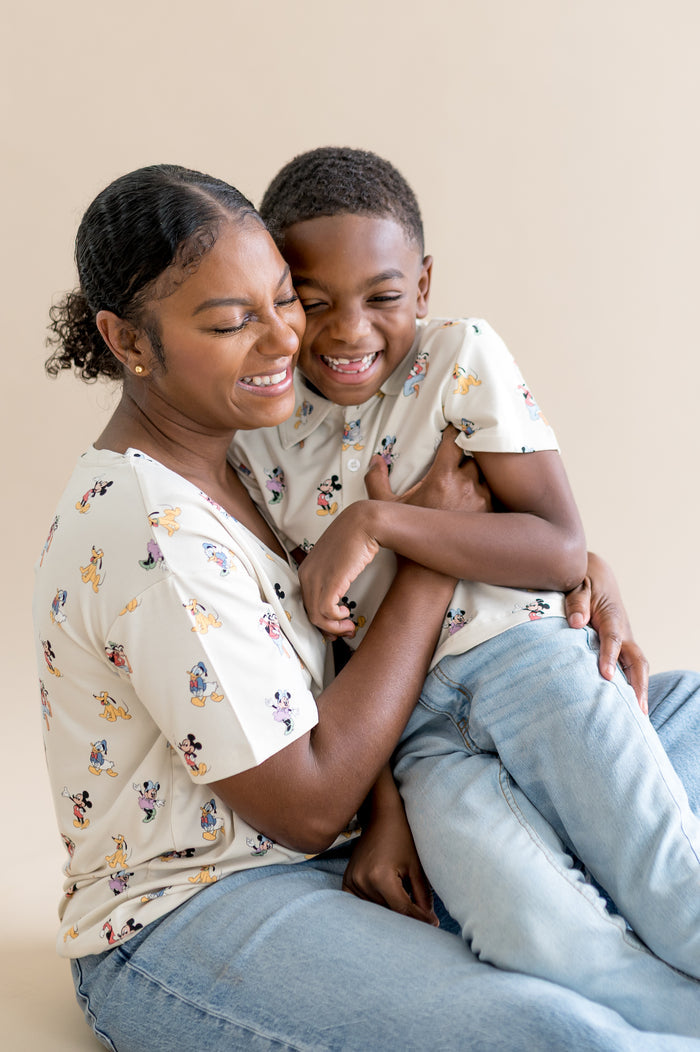 Mom and child wearing matching mickey mouse patterned shirts