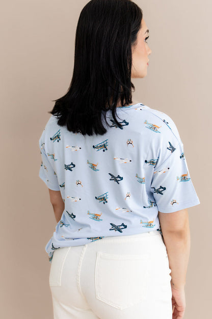 The back of the Women's Relaxed Fit V-Neck in Take Off shown on a model paired with cream pants